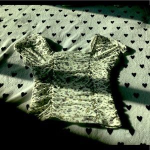 Shirt with ruffled indents and little flower designs.